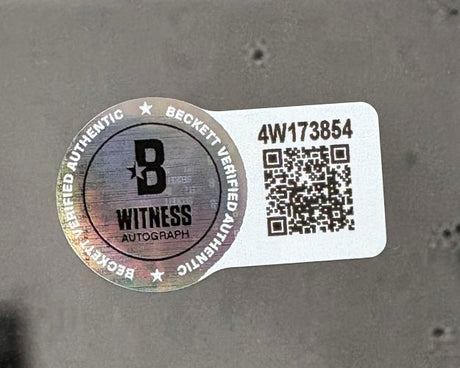 A Beckett Witness Authentication sticker with holographic seal, QR code, and 4W173854 appears on this Sports Integrity Justin Jefferson Signed 16x20 Minnesota Vikings Photo vs Bills to confirm the autograph's authenticity.