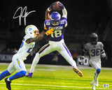 A Justin Jefferson Signed 16x20 Minnesota Vikings Photo vs Chargers by Sports Integrity shows Jefferson in a purple jersey leaping for a catch, defended by a player in white, with another in gray watching; autograph on top left.