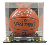 A Karl Malone Utah Jazz Signed Spalding I/O NBA Basketball is displayed in a clear acrylic case with a black and gold base. The ball, authenticated by JSA ITP, features the NBA logo and is offered by Sports Integrity.