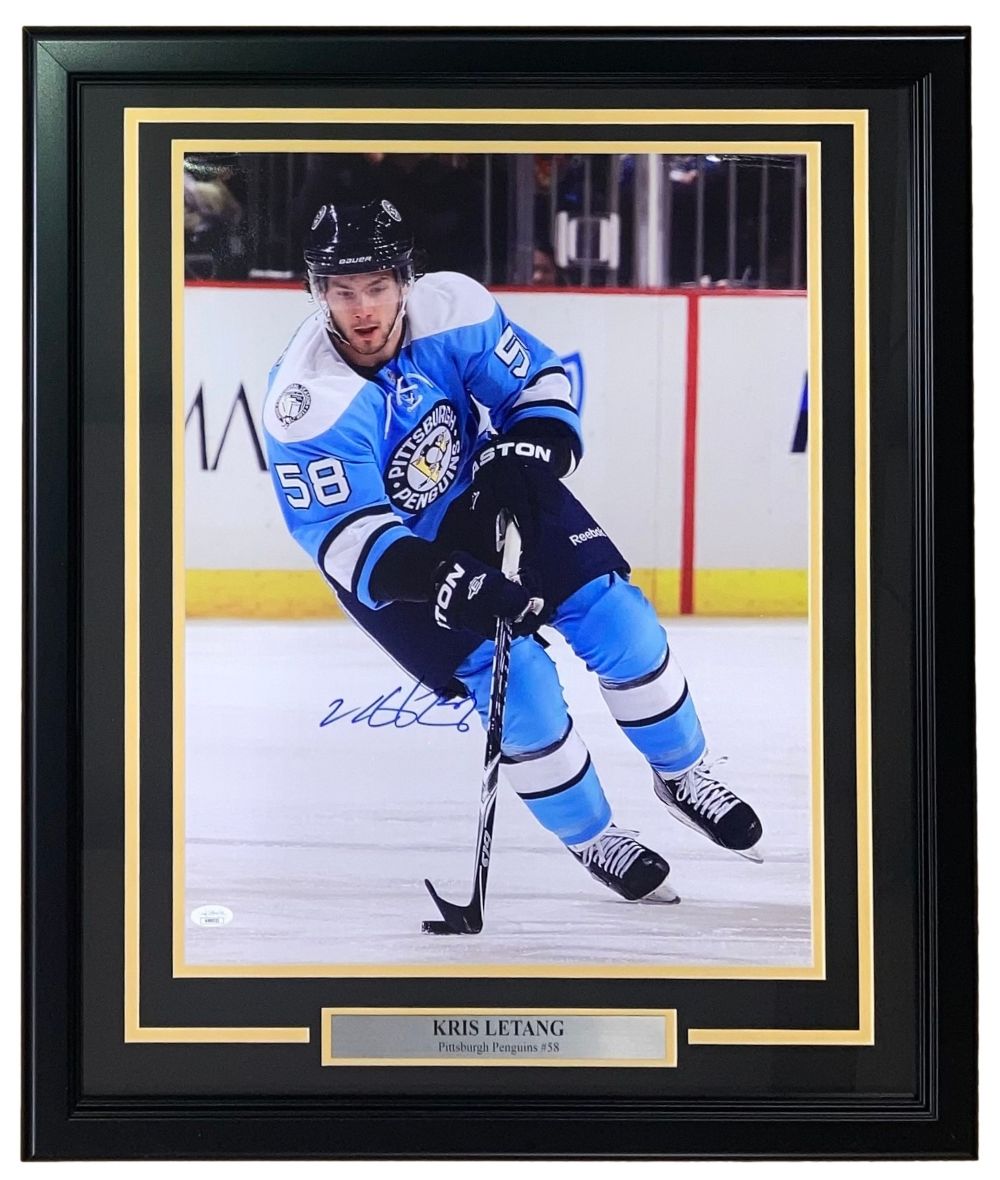 The Sports Integrity Kris Letang Signed Framed 16x20 Pittsburgh Penguins Photo (JSA) shows Letang, #58, in a blue jersey skating on ice. Includes autograph and nameplate with Kris Letang’s name and team.