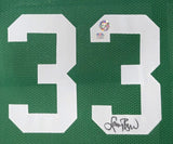 The Sports Integrity Larry Bird Boston Signed Framed Green Basketball Jersey features white number 33, a PSA/DNA authentication sticker, and Larry Bird’s autograph at the lower right of the number.