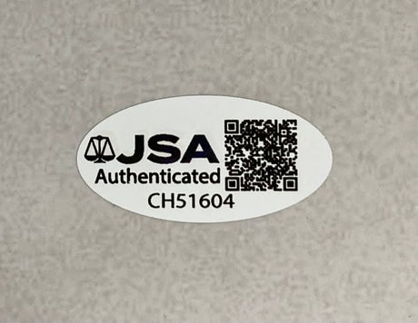 A Sports Integrity Lawrence Taylor Signed 16x20 New York Giants Cunningham Sack JSA QR comes with an oval sticker displaying "JSA Authenticated CH51604" and a QR code on a plain, light-colored surface.