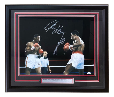 The Sports Integrity Sugar Ray Leonard Thomas Hearns Signed Framed 16x20 Boxing Photo features both autographs, a plaque with their names, and shows the two boxers in the ring with a referee in the background.