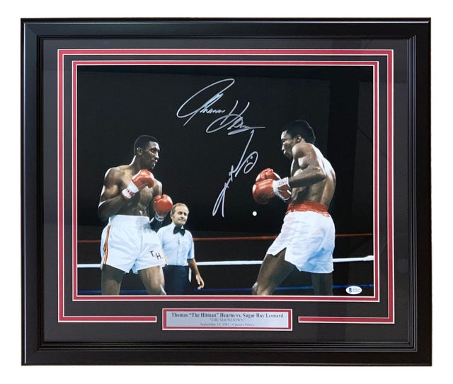 The Sports Integrity Sugar Ray Leonard Thomas Hearns Signed Framed 16x20 Boxing Photo features both autographs, a plaque with their names, and shows the two boxers in the ring with a referee in the background.