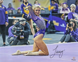 Livvy Dunne poses on the floor in a purple LSU leotard, surrounded by spectators, in this 16x20 signed photo from Sports Integrity, featuring the LSU Tigers and available at Fanatics.