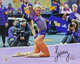 Livvy Dunne poses on one knee during a floor routine in this signed 8x10 LSU Tigers photo by Sports Integrity, wearing a purple leotard with an autograph visible in black ink.