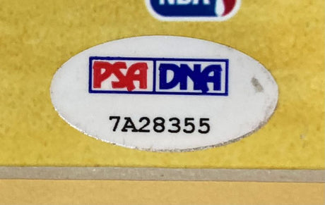 This Magic Johnson Signed Framed 16x20 Lakers Collage Photo by Sports Integrity shows a PSA/DNA oval sticker, with red and blue boxes above serial number 7A28355, on a yellow background and part of an NBA logo at the top edge.