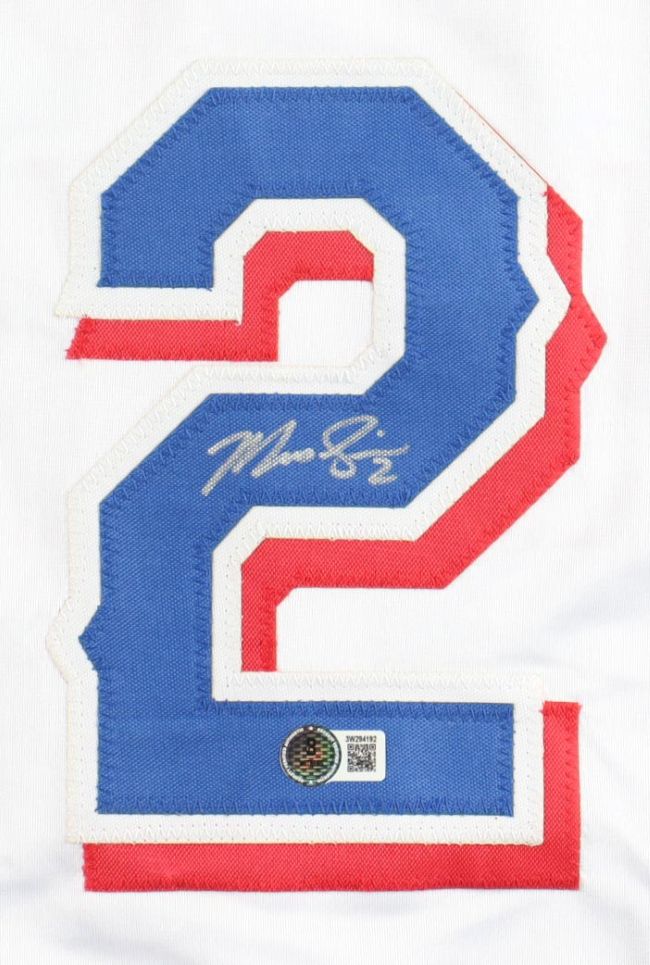 A large blue number 2 outlined in white and red is stitched onto the Marcus Semien Texas Signed White Baseball Jersey by Sports Integrity, featuring his silver signature and a BAS authentication sticker on the number.