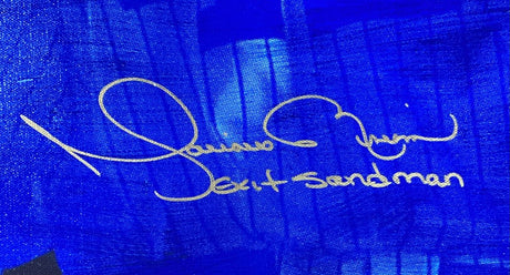 A gold Mariano Rivera signature appears on a blue background above the words "Exit Sandman" in matching gold ink on this 24x40 New York Yankees Sports Integrity canvas, JSA authenticated and LE/42.