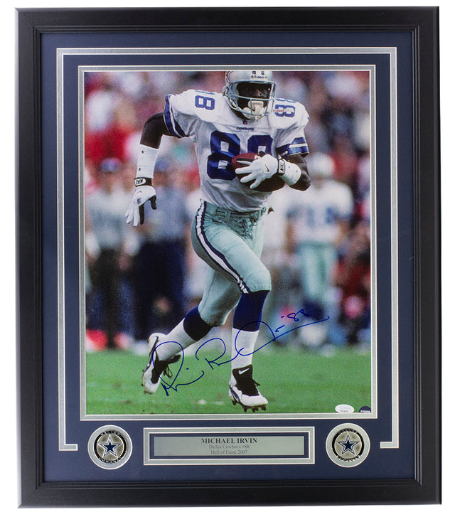Sports Integrity Michael Irvin Signed Framed 16x20 Dallas Cowboys Photo JSA features Irvin running on the field, autographed in blue marker. The frame includes a plaque and two star emblems at the bottom.