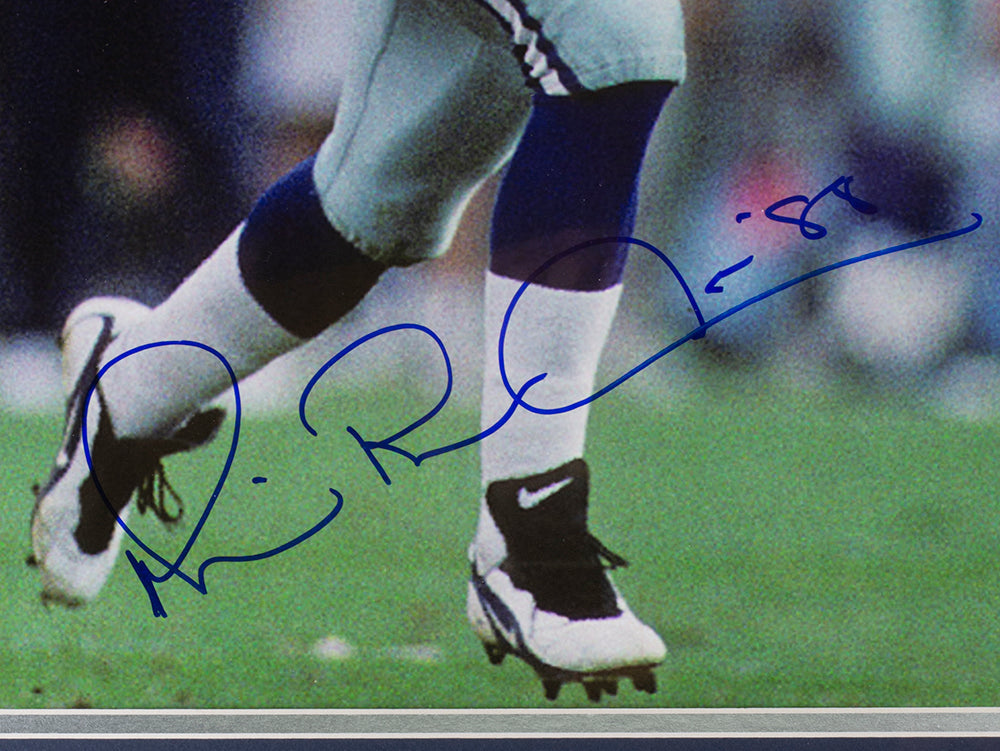 Close-up of a football player’s legs on the field in white pants, blue socks, and Nike cleats. Features Michael Irvin's large blue autograph. Sports Integrity Michael Irvin Signed Framed 16x20 Dallas Cowboys Photo (JSA).