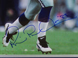 Close-up of a football player’s legs on the field in white pants, blue socks, and Nike cleats. Features Michael Irvin's large blue autograph. Sports Integrity Michael Irvin Signed Framed 16x20 Dallas Cowboys Photo (JSA).