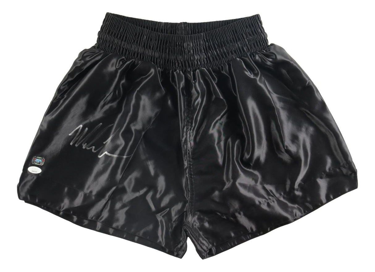 Sports Integrity's Mike Tyson Signed Custom Black Boxing Trunks feature a white signature and two authentication stickers on the left leg.