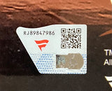 A close-up of a label for the Sports Integrity The Miz Signed Framed 16x20 WWE Photo Fanatics, featuring code RJ89847986, a red stylized F logo, QR code, and holographic security strip on a dark background.