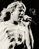 The Sports Integrity Joe Elliott Signed 11x14 Black and White Def Leppard Photo (JSA ITP) features the long-haired singer passionately performing onstage, T-shirted, gripping a mic, with his autograph in the upper right corner.
