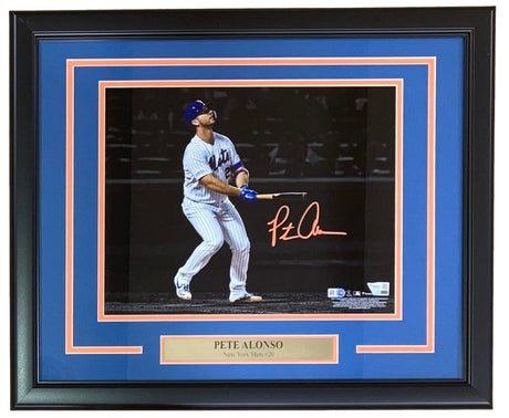 This Sports Integrity Pete Alonso Signed Framed 11x14 New York Mets Photo features Alonso mid-swing, his autograph across the image, team plaque, and blue-orange matting. Authenticated by Fanatics.
