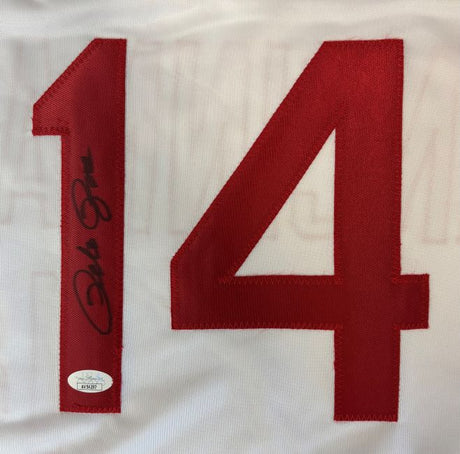 The Sports Integrity Pete Rose Cincinnati Signed White Baseball Jersey features a large red number 14, with Pete Rose's autograph in black ink on the left of the "1" and a small JSA authentication sticker below the number.