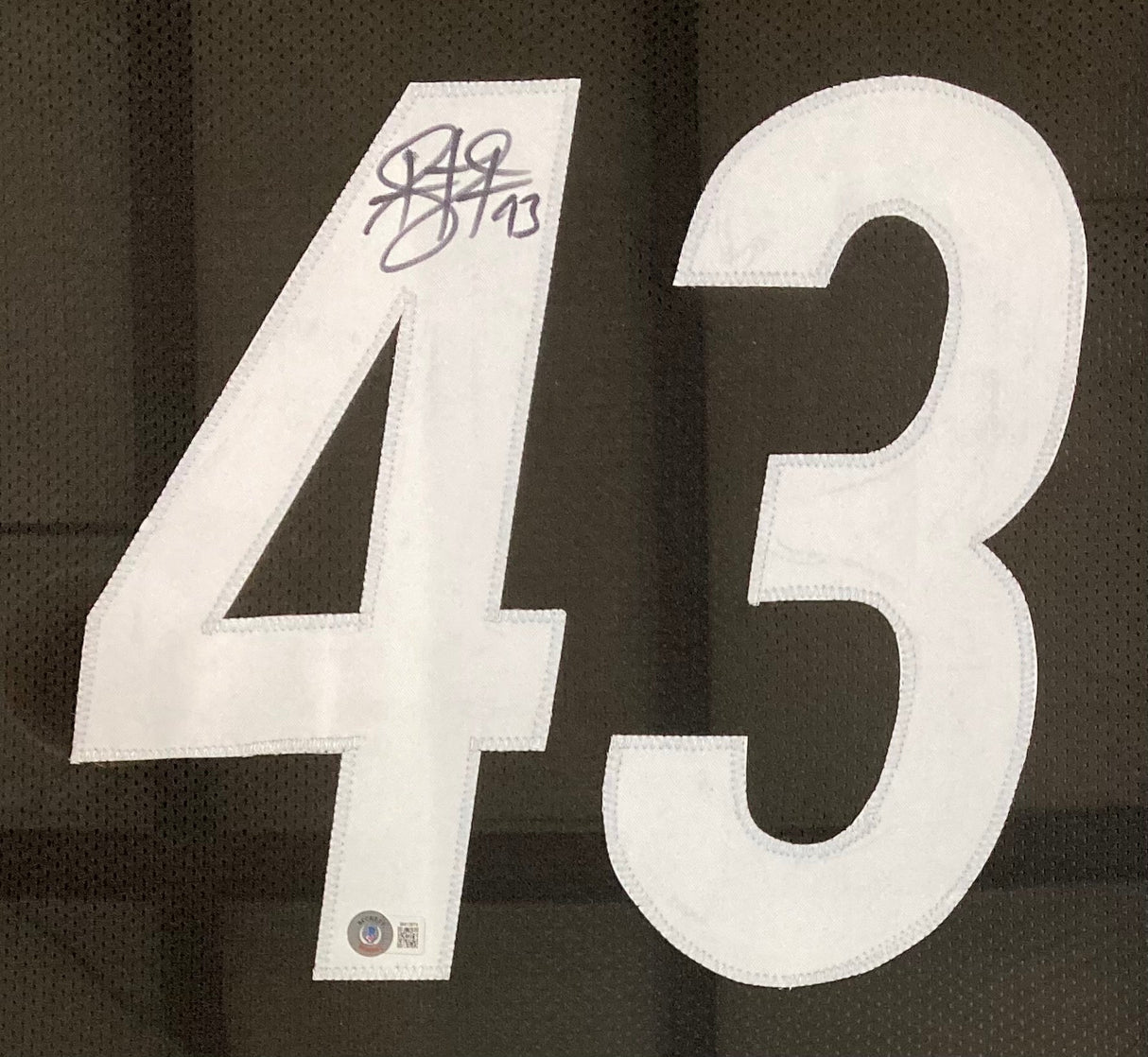 Troy Polamalu Pittsburgh Signed Framed Custom Black Football Jersey by Sports Integrity features a white 43 on black fabric, Polamalu's signature and the number 43 in black ink above the 4, plus a small label left of the number.