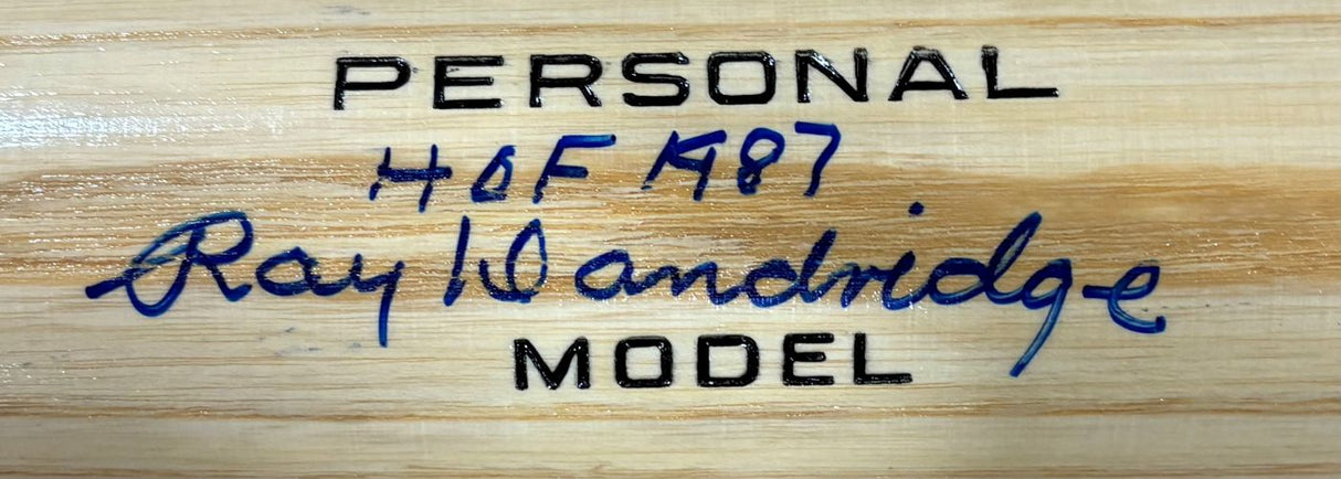 Close-up of a tan Adirondack bat by Sports Integrity, featuring "PERSONAL MODEL" and "H&B 487" in black, with Ray Dandridge's blue signature and HOF 1987 inscription from the Newark Eagles, authenticated by JSA.