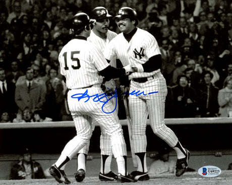Three New York Yankees in pinstripes celebrate on the field in this Sports Integrity Reggie Jackson Signed B&W 8x10 Photo (BAS), with a blue autograph visible and cheering fans in the background.