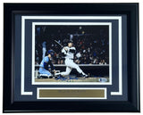 Sports Integrity Reggie Jackson Signed Framed 8x10 Photo shows him batting in the 1981 ALDS for the Yankees, with a catcher in blue gear behind. Includes a name plaque and BAS authentication.