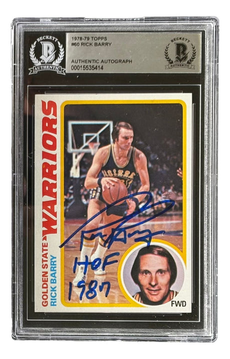 The Sports Integrity Rick Barry Signed 1978/79 Topps #60 Warriors Trading Card features his autograph with "HOF 1987" in blue ink and comes in a Beckett BAS Authentic Autograph holder.