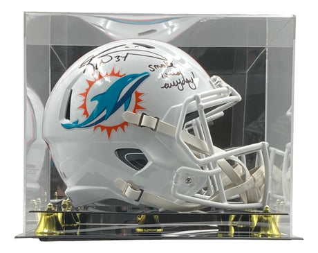 The Sports Integrity Ricky Williams Signed Dolphins FS Speed Rep Helmet features a black marker signature and teal-orange logo, displayed in a clear case with black and gold base. Includes BAS authentication and "Smoke Everyday" inscription.