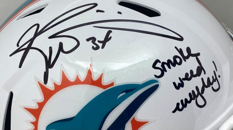 The Sports Integrity Ricky Williams Signed Dolphins FS Speed Replica Helmet features two signatures and the handwritten phrase "Smoke Weed Everyday!.