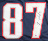 A close-up of the Sports Integrity Rob Gronkowski New England Signed Alternate Blue Football Jersey, featuring a large white and red number 87 with his autograph in black marker on the number 7. PSA/DNA Holo authenticated.