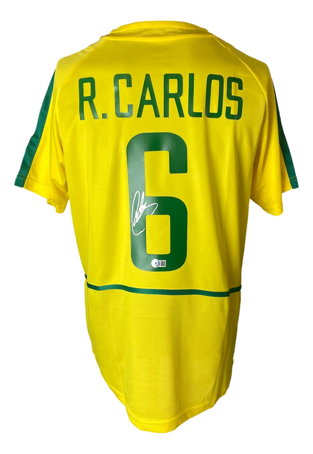 A Brazil yellow Nike XL soccer jersey by Sports Integrity, signed by Roberto Carlos with his name and number 6 on the back.