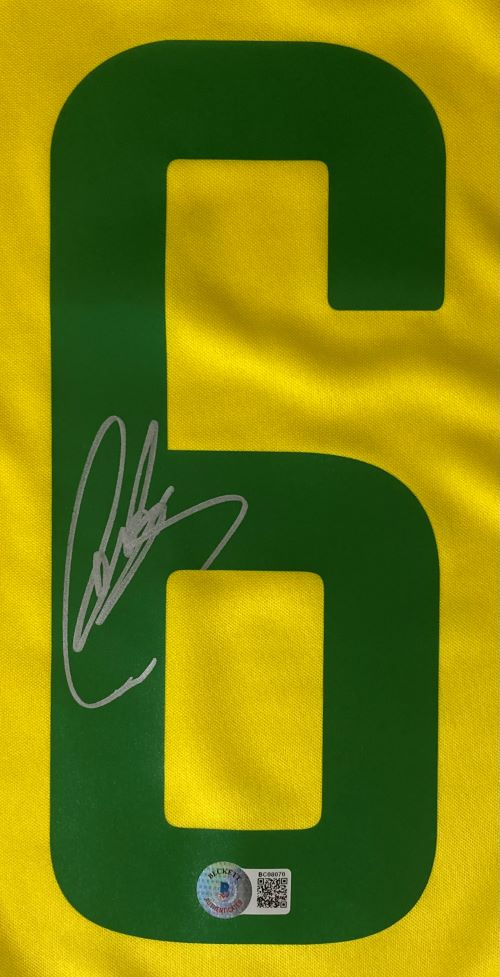 The Sports Integrity Roberto Carlos Signed Brazil Yellow Nike XL Soccer Jersey features a large green number 6 signed in silver, with a security hologram sticker and QR code at the bottom of the number.