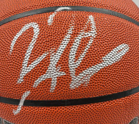 Close-up of a Dennis Rodman Chicago Bulls Signed NBA Wilson I/O Basketball by Sports Integrity, with a bold silver autograph spanning the textured surface and black seams. Includes BAS authentication and display case.