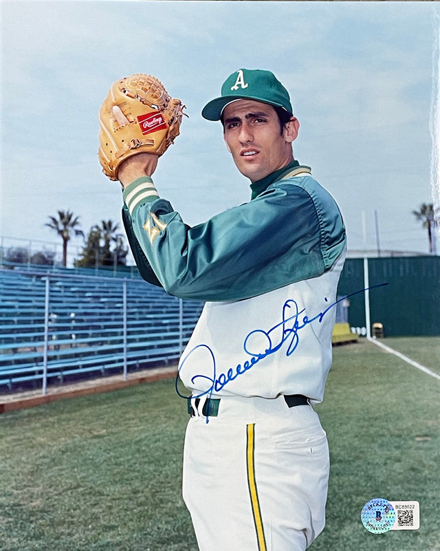 The Sports Integrity Rollie Fingers Signed 8x10 Oakland Athletics Baseball Photo (BAS 622) features Fingers in uniform on the field, holding a glove and ball, with empty blue bleachers and palm trees in the background.