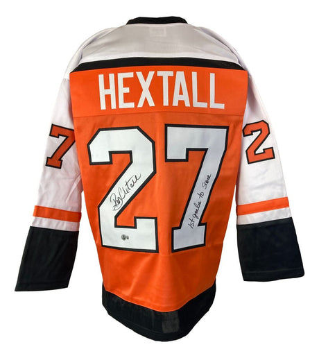 This Sports Integrity Ron Hextall Philadelphia Flyers orange hockey jersey is signed on the number 2 with "15 goals to score" inscribed on the number 7. It's a BAS authenticated collectible honoring the first goalie to score.