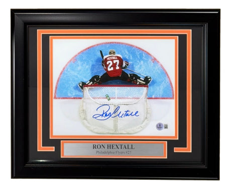 Sports Integrity Ron Hextall Signed Framed 8x10 Photo features the Flyers goalie in black and orange stopping a puck. Includes signature, plaque with "Ron Hextall, Philadelphia Flyers #27," and BAS authentication.