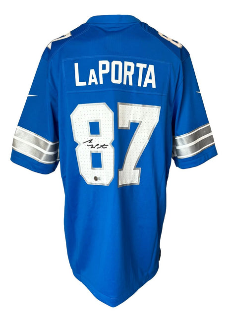 A Sam LaPorta Signed Detroit Lions Blue Nike Game Replica Jersey by Sports Integrity, featuring silver and white details, with LaPorta's name, number 87, and a signature on the number 8.