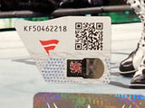 A close-up of a tamper-evident authentication sticker with code KF50462218, QR code, red logo, and holographic strip on a Sami Zayn Signed Framed 8x10 WWE Photo by Sports Integrity.