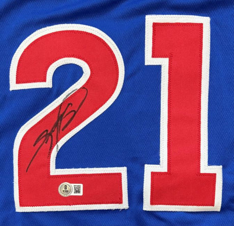 A close-up of the Sammy Sosa Chicago Signed Blue Slammin Sammy Baseball Jersey by Sports Integrity, featuring large red and white number 21 with Sosa's autograph and a BAS authentication sticker under the left digit.