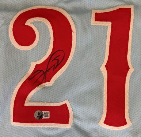 A close-up of the Sports Integrity Sammy Sosa Chicago Signed Light Blue Baseball Jersey BAS, featuring large red and white 21 numbers, Sammy Sosa's autograph on the 2, and an authentication sticker below.