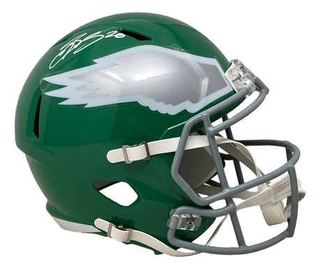 The Sports Integrity Saquon Barkley Signed Eagles FS Kelly Green Replica Speed Helmet (PSA/DNA) features a green helmet with white/silver wing design, gray facemask, white chin strap, and Saquon's signature in white ink.