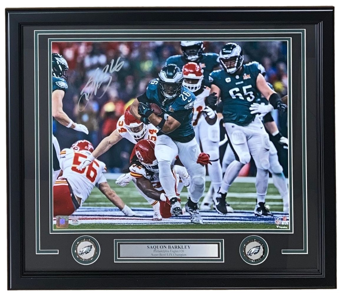 Sports Integrity Saquon Barkley Signed Framed 16x20 Eagles Super Bowl 59 LIX Photo, authenticated by PSA/DNA, features Barkley in action as two opponents try to tackle him.