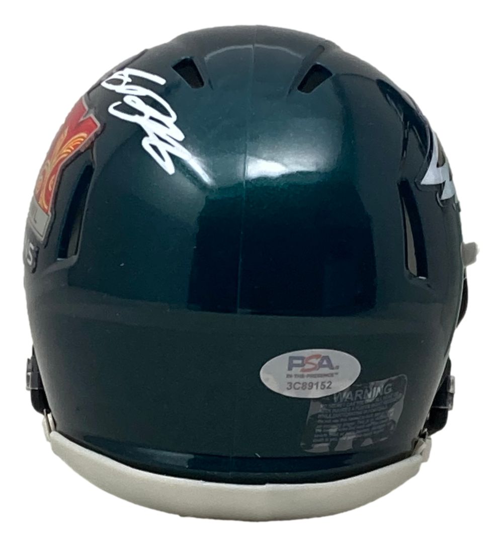 The Sports Integrity Saquon Barkley Signed Half Eagles & Half Super Bowl 59 LIX Mini Helmet features a PSA/DNA sticker, warning label, white autograph, and part of the logo on its dark green back.