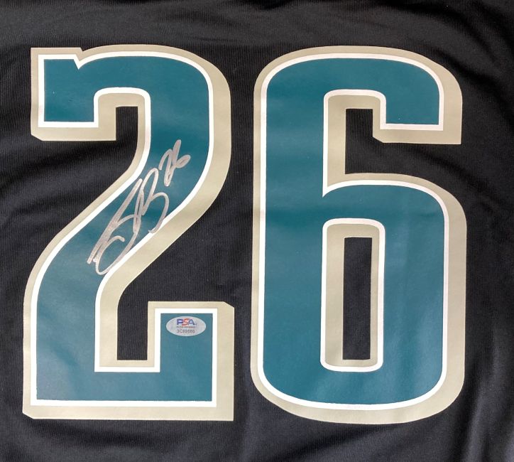 A close-up of the Saquon Barkley Signed Philadelphia Eagles Super Bowl 59 LIX Black Nike Jersey by Sports Integrity, featuring a large teal and white number 26 with Barkley's white autograph and a PSA authentication sticker.