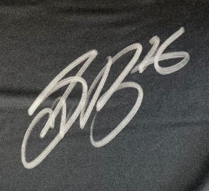 A bold, stylized silver autograph featuring the number 16 appears on black fabric of the Saquon Barkley Signed Philadelphia Eagles Super Bowl 59 LIX Nike Limited Jersey by Sports Integrity.
