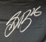 A bold, stylized silver autograph featuring the number 16 appears on black fabric of the Saquon Barkley Signed Philadelphia Eagles Super Bowl 59 LIX Nike Limited Jersey by Sports Integrity.