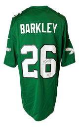The Sports Integrity Saquon Barkley Signed Eagles Kelly Green Nike Game Replica Jersey features BARKLEY and number 26 in white, white and black trim, team logos on the sleeves, and a signature on the 6. PSA/DNA certified.