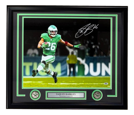 Sports Integrity Saquon Barkley Signed Framed 16x20 Eagles Kelly Green Jersey Photo, featuring Barkley running with the ball, nameplate, two Eagles logos; PSA/DNA ITP authenticated.