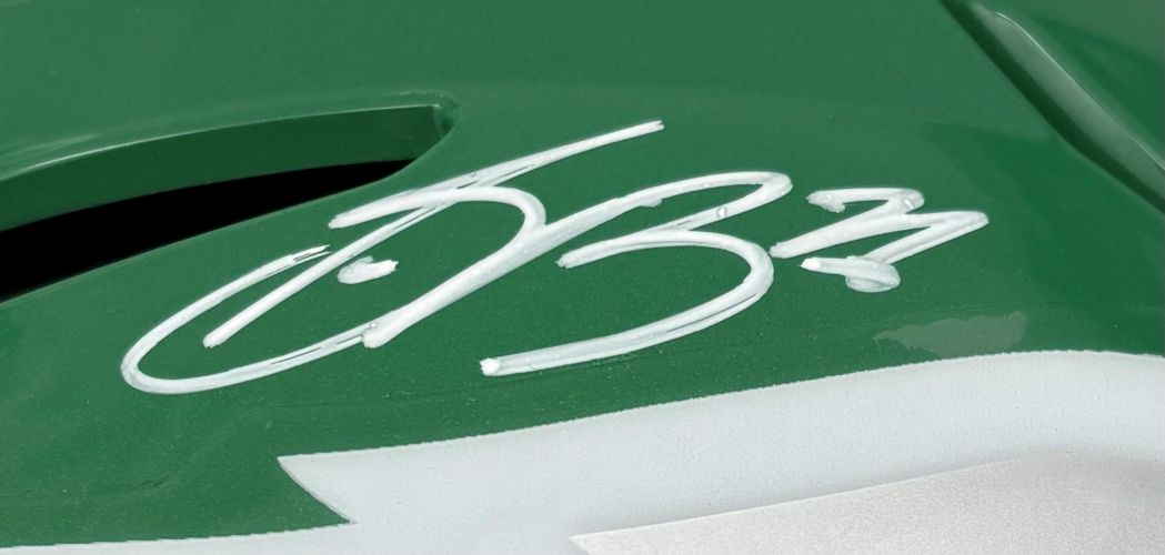 Close-up of a Saquon Barkley signed Eagles FS Kelly Green Authentic SpeedFlex Helmet by Sports Integrity, featuring a white stylized signature with the number 53, authenticated by PSA/DNA.