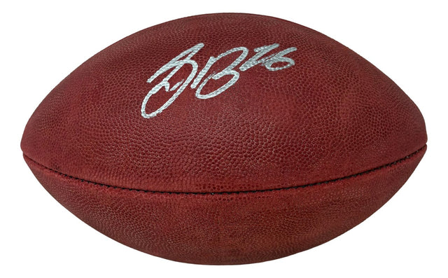 A Saquon Barkley signed Philadelphia Eagles Duke logo football by Sports Integrity with PSA/DNA, featuring a brown textured surface and white signature, displayed on a white background.