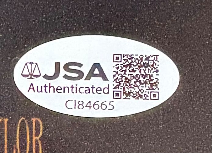 Sports Integrity Sean Astin Signed 11x17 Rudy Photo features an oval sticker with JSA Authenticated text, a scales of justice icon, QR code, and code CI84665 on a dark background.
